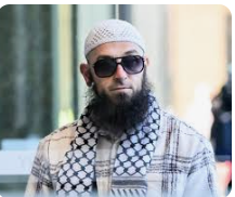 MarkoS2075's tweet photo. Two citizens, starkly contrasted: 

One fights for our country, risking his life for our freedom—Ben Roberts-Smith, VC, MG, former Australian SASR corporal awarded the Victoria Cross. 

The other...Wissam Haddad (aka Abu Ousayd), is a Sydney-based radical Islamic preacher who ran the shuttered Al Madina Dawah Centre in Bankstown. In July 2025, Australia's Federal Court branded him "fundamentally racist and antisemitic" for vile online sermons post-October 2023, calling Jews "treacherous," "murderous," and "descendants of apes and pigs"—with authorities linking him to a terrorism recruitment hub tied to pro-ISIS networks.

And one of them is being arrested.
