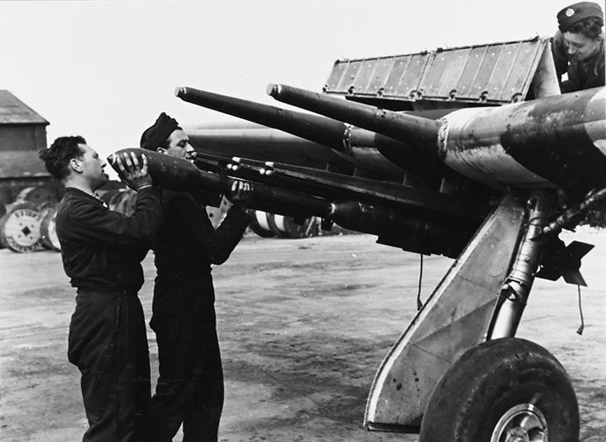 BritishHistorym's tweet image. 3 in, 60 pdr SAP, Rocket Projectiles being loaded onto the launch rails of an RAF Hawker Typhoon, circa 1944.

A pair of 20mm cannon barrels are visible above the launch rails.

____
#britishhistory #raf