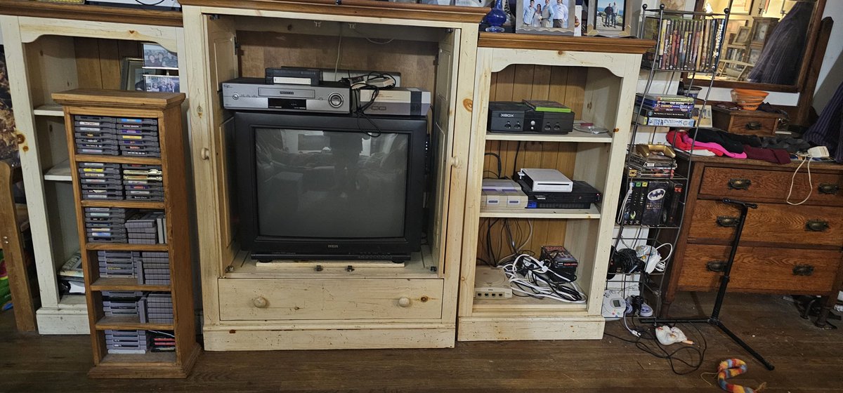 ChefOso89's tweet photo. @matthewhenzel My current retro setup.
I gotta move some of the power cables behind the unit, but this build is ready to go with all consoles shown.
S-Video with a switcher in the back, some consoles share an AV cable (I swap as needed), and The NES is hooked up to the VCR. https://t.co/MbREUj4SI3