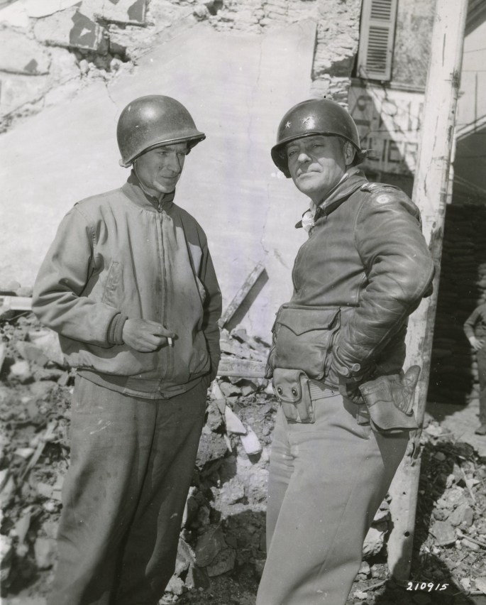 WW2HQ's tweet image. Photo caption: "At Nettuno, Italy, Ernie Pyle, war correspondent, and Major General Lucian Truscott stand in front of Corps Headquarters." Circa March 1944. #WWII #WW2