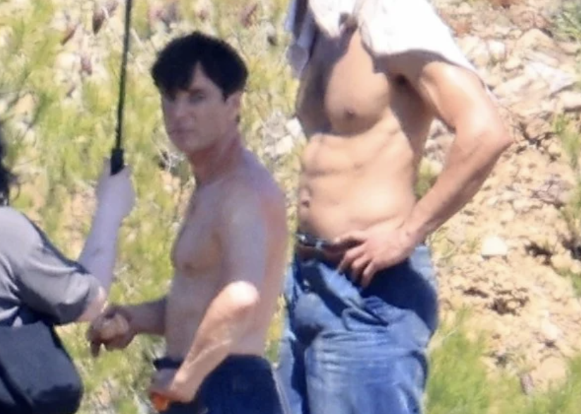 New images of Cillian Murphy emerge from the set of Damien Chazelle's prison-based psychological drama in Greece. 

Murphy is seen shirtless, hanging out with the cast and crew filming a scene that appears to depict inmates engaged in hard labor outside the prison, breaking rocks