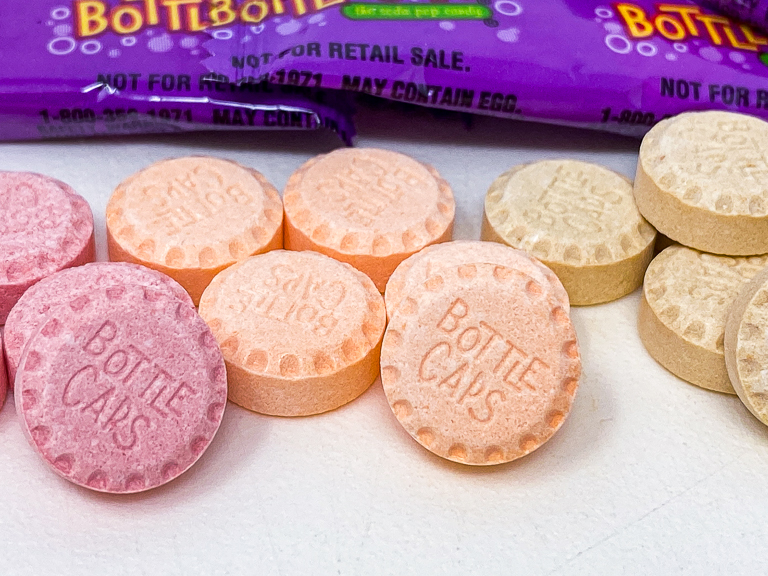 Bottle Caps candy used to look like the image on the left. Since 2009, they are smaller and they look like the image on the right, with just a flat bottom. I'm pretty sure they used to taste better as well.