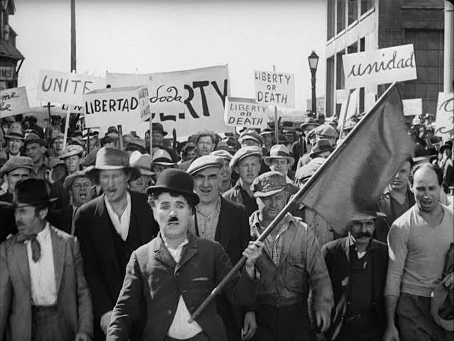 ponrajofficial's tweet photo. #filmdiaryclassicals 5 •

🎬 #Themoderntimes 1936 ⏳1h27m ⭐8.5 Dir- #CharlesChaplin #Romanticcomedy #Satire #Slapstick #Comedy #Drama #Romance 🎭💖😭

#oneline of the film 

தொழிற்புரட்சியின் எந்திரத்தனமான வாழ்க்கையில் சிக்கித் தவிக்கும் ஒரு சாமானிய மனிதன், வறுமை மற்றும் சவால்களைத் தாண்டி தனது துணையுடன் மகிழ்ச்சியைத் தேடிப் பயணிப்பதே கதை.

#Synopsis 

ஒரு பெரும் தொழிற்சாலையில் திருகாணிகளை (Nuts) முறுக்கும் வேலையைச் செய்யும் நாயகன் #Thetramp இடைவிடாத எந்திரத்தனமான வேலையினால் மனநலம் பாதிக்கப்பட்டுச் சிறைக்குச் செல்கிறான். சிறையிலிருந்து விடுதலையான பின், எதிர்பாராத விதமாக ஒரு கம்யூனிச ஊர்வலத்திற்குத் தலைமை தாங்கியதாகக் கருதி மீண்டும் கைது செய்யப்படுகிறான். அங்கு தற்செயலாக ஒரு சிறைக்கலகத்தைத் தடுத்து நிறுத்தியதற்காக மரியாதையுடன் விடுவிக்கப்படுகிறான்.

வெளியே வந்தவன், உணவிற்காகத் திருடிப் போலீசிடம் சிக்கவிருக்கும் ஒரு ஆதரவற்ற பெண்ணைச் (The Gamin) சந்திக்கிறான். அவளைக் காப்பாற்ற அந்தப் பழியைத் தன்மீது ஏற்றுக்கொள்கிறான். இருவரும் இணைந்து ஒரு மகிழ்ச்சியான வாழ்க்கையை வாழக் கனவு காண்கின்றனர். 

வறுமையின் பிடியில் சுழன்ற நிலையில், நாயகன் ஒரு உணவகத்தில் பாடகனாகச் சேர்ந்து புகழடைகிறான். பழைய குற்றச் செயலுக்காக, அந்தப் பெண்ணைப் பிடிக்கப் போலீசார் வருவதால் இருவரும் அங்கிருந்து தப்பி ஓடுகின்றனர்.

வேலை இழந்து சோர்ந்து போயிருக்கும் நிலையில் அந்தப் பெண்ணிடம், "மனம் தளராதே, புன்னகை செய்" என்று நம்பிக்கை ஊட்டும் நாயகன், அவளுடன் கைகோர்த்து ஒரு புதிய விடியலை நோக்கிச் சாலையில் நடந்து செல்வதுடன் படம் நிறைவடைகிறது. 
Life uncertain… but keep moving forward. 

➤ இப்படம் #Industrialcapitalism மீது நேரடியான தாக்குதலை தொடுத்தது.  💼 பொருளாதார மந்தநிலை கவிழ்ந்த 1930களின் #GreatDepression காலத்தை இது பிரதிபலிக்கிறது. ஒரு “காலத்தின் ஆவணம்” போல பார்க்கப்படுகிறது.

➤ சாப்ளினின் மற்ற படங்களைப் போல இதிலும் நகைச்சுவைக்கு இணையாக ஒரு மெல்லிய சோகம் #Pathos கலந்து, எந்திரமய உலகில் மனிதர்கள் வெறும் கருவிகளாக மாற்றப்படுவதைச் அங்கதச் சுவையுடன் #Satire காட்டினார். 

🧭 Final Take -  
🔹இது ஒரு “old movie” அல்ல -  #relevantsystemanalysis ஆகும். #workpressure 😓 #automation 🤖
#corporateroutine என 1936-ல் சொன்ன இந்த விஷயங்கள் இன்று இன்னும் தீவிரமடைந்துள்ளன.  
Visual storytelling ல் அசத்தும் இந்த Cinema,  ஒரு 'film school in itself' எனலாம். 

🔹Visual satire, character design, pacing என சினிமாவின் Grammar-ஐ shape பண்ணியுள்ளார் சாப்ளின். 

🔹You’re not just watching history  — you’re watching your present. 

  🔊 1927-இல் 'The Jazz Singer' வருகைக்குப் பிறகு மௌனப் பட யுகம் முடியத் தொடங்கியது. ஆனால், சாப்ளின் கிட்டத்தட்ட 10 ஆண்டுகள் (1927 - 1936) பேசும் படத் தொழில்நுட்பத்தை (Talkies) மிகத் தீவிரமாக எதிர்த்தார். அது குறித்து அடுத்த பதிவில் பார்க்கலாம்🔥 💥 

உலக சினிமாவை அறிய வைக்கும்  இந்த புதிய முயற்சிக்கு ஆதரவளியுங்கள். 🙏🏻💚🫰🏻 

@Reviewbyamit @aaradhana_gowri @balaji_213 @Absolutlycinema @NithyViews @TheCinediction @LearnEasy11 @cinee_mazhaii_ @SuryaYuva2tn @Nithya_vin @cinemaGems89 @Missed_Thrills   
@VenkeyReacts @Kathira46482094  @top2bot15 @Ghostgova @Sathish_dsv @karthick_45 @Nidhura_Views  @Kirank_3108 @MoveyFreaky05, @tamilhollywood2 @Nandhan_Talkz @KUDALINGAM49671 @NikhilPoojary01 @KarasingamAc @Just__Cinema @Buddythala @Saravan_movieRW  @_makeanoffer @shivtweetzz @Mr_Nobody_das @AjayRenald  @SivaDas45 @24thCS @MrKnightjegan @CINEMA_TREND_ 
@ksrajabe