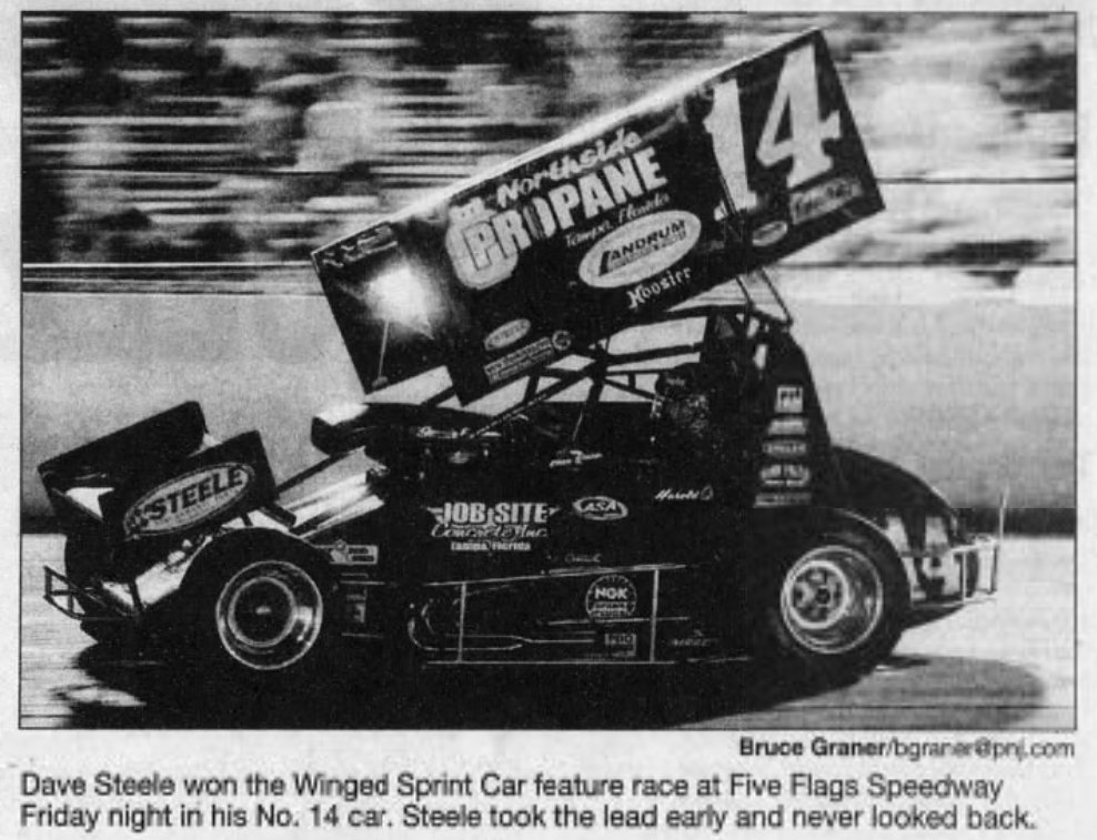 Dave Steele powers to his second and last career sprint car feature win at Five Flags Speedway on July 10, 2009 driving the No. 14 car owned by Lenny Puglio (Pensacola News Journal, 7-11-2009)