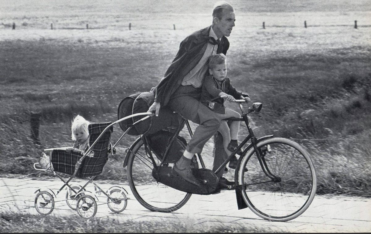 A 1966 photo from The Netherlands dubbed the “Dutchiest father of all time” by Rudi Herzog, 1966, captures a father fully embracing classic mid-1960s Dutch practicality and style likely complete with bicycle, tidy family scene, and understated charm.

In 1960s, daily life in the