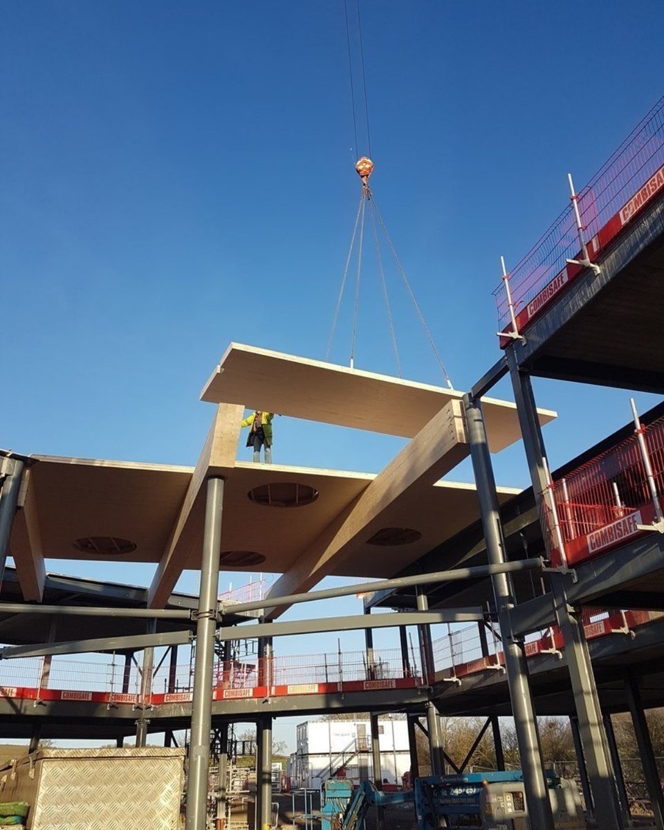 BucklandTimber's tweet photo. #CLT takes a simple idea and makes it structural. By layering timber at right angles, panels gain strength in both directions - ideal for large floors and walls, delivered to site ready to install. Used here at Wellington Academy to form a two-storey atrium ceiling. https://t.co/QlaZCIvIzU
