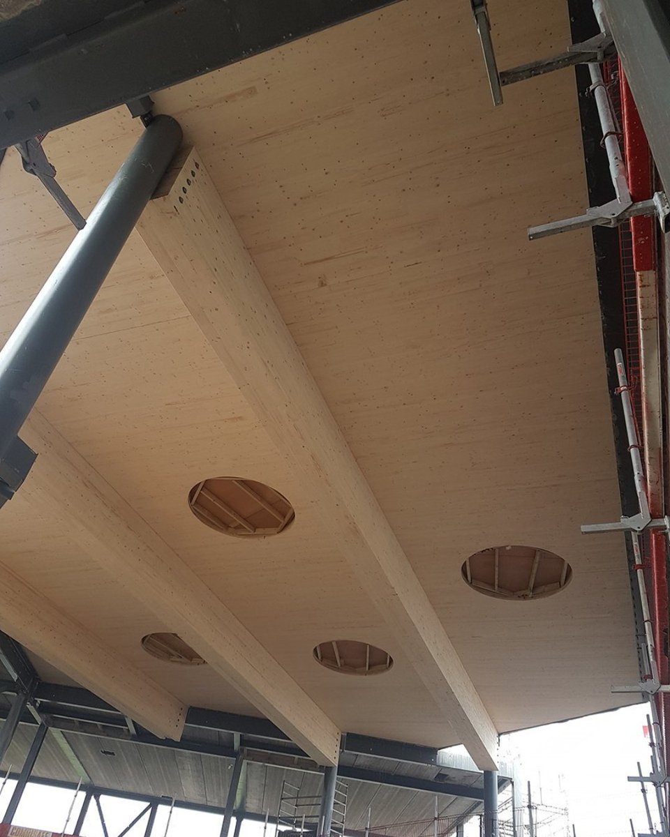 BucklandTimber's tweet photo. #CLT takes a simple idea and makes it structural. By layering timber at right angles, panels gain strength in both directions - ideal for large floors and walls, delivered to site ready to install. Used here at Wellington Academy to form a two-storey atrium ceiling. https://t.co/QlaZCIvIzU