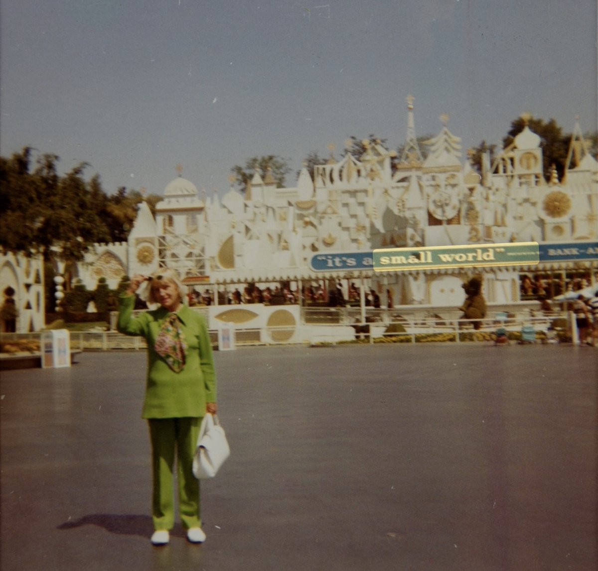 JimShull's tweet image. #SmallWorld will celebrate its anniversary on May 28th.  One Imagineer (in lime green) stands on asphalt in front of the building with potted trees on the roof.  Curious about the rest of the story?  YouTube.com/jimhshull