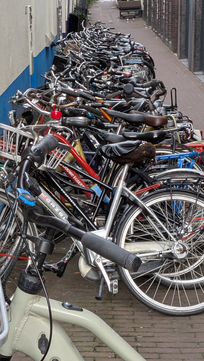 AlanMusselman's tweet photo. Crazy amount of bikes parked in Amsterdam https://t.co/4UlA9wapyT