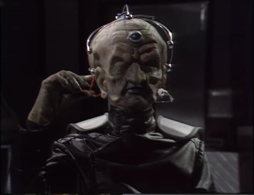 Serious question

If we went back into say 1975 to see Davros

Should he look like modern Julian Bleach's Davros but younger, or like Michael Wisher originally looked?
