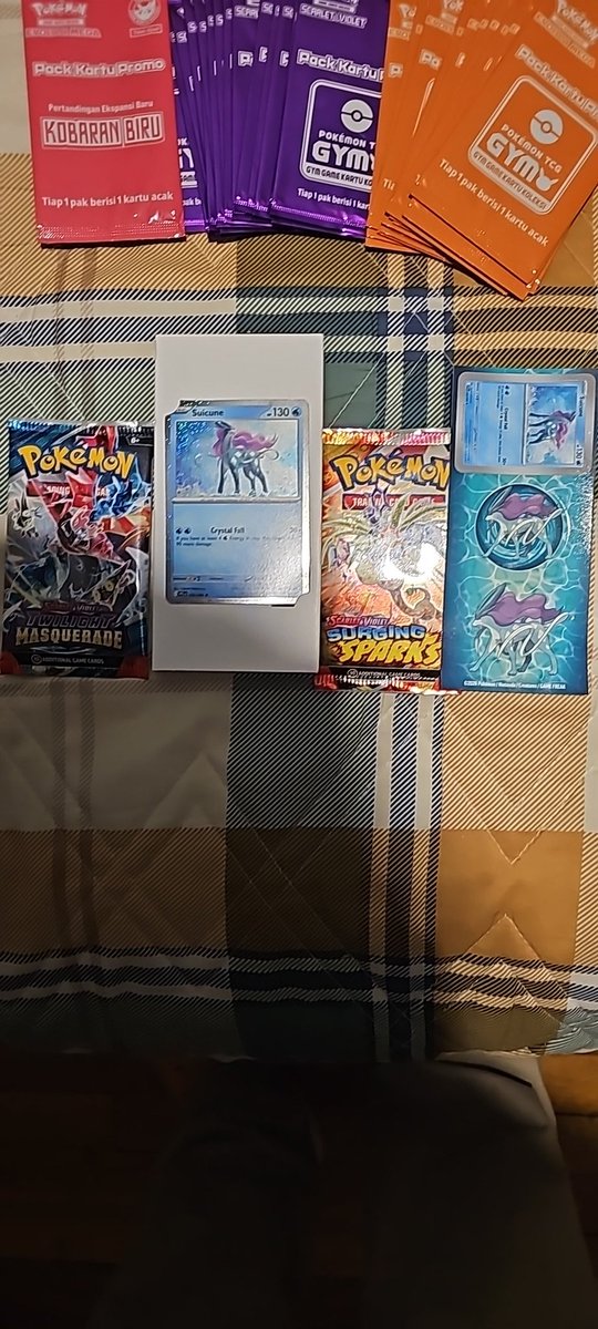this_what82459's tweet photo. @PokeHEX5555 Me and my son pick these up when we find them. Currently 1 Surging, 1 Masquerade, 1 Promo and a sheet with three stickers. https://t.co/YfKRcRdq7q