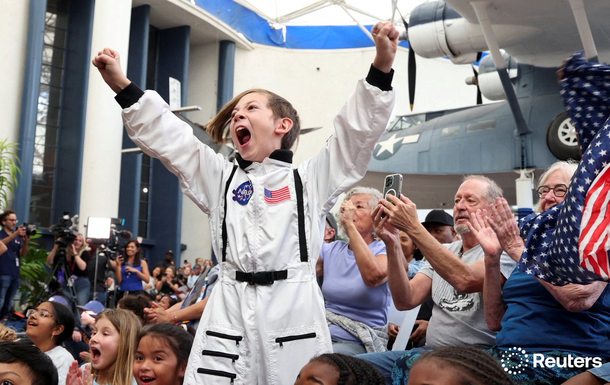 Crowds watch the Artemis II Orion capsule splash down off the coast of San Diego at the Air and Space Museum in San Diego, California. Photo by Sandy Huffaker