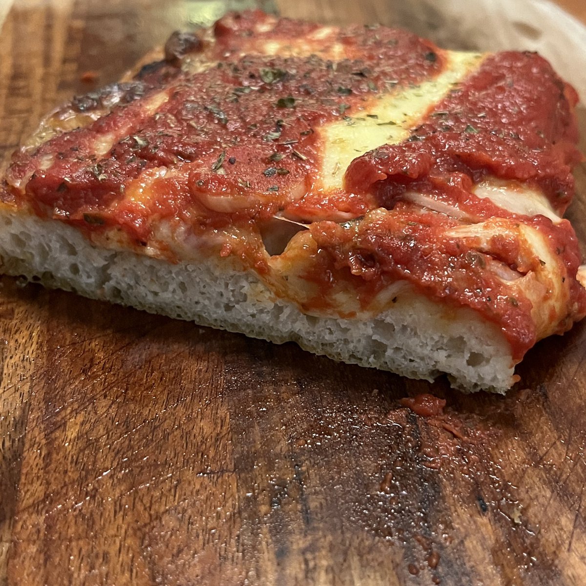 montch's tweet photo. DIY Sicilian-style pizza: Round 2!

Went for significantly more hydration in the dough this time (around 80%). Couldn’t even handle it without oiled hands.

The result: more of a focaccia-like base with bigger air pockets. Definitely lighter slices with a crispier bite.👌

Seems this is “the way” for Sicilian-style slices from NYC, based on what I’ve seen online.

I kept everything else exactly the same, though. Why mess with a good thing?

In the end, I’m not sure I have a clear winner between the two approaches. Hey, they’re both tasty and they’re both pizza. What more can I say?😆