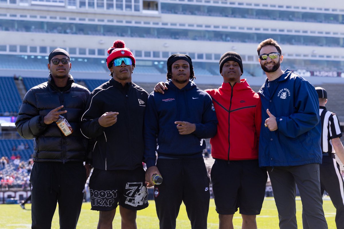 StorrsCentral's tweet photo. Got some former Huskies in the building 🏈

Reymello Murphy, Skyler Bell, D’Mon Brinson and Malachi McLean all in attendance to support the squad here in East Hartford 🔥🔥

#BleedBlue https://t.co/WVRdBNivWr