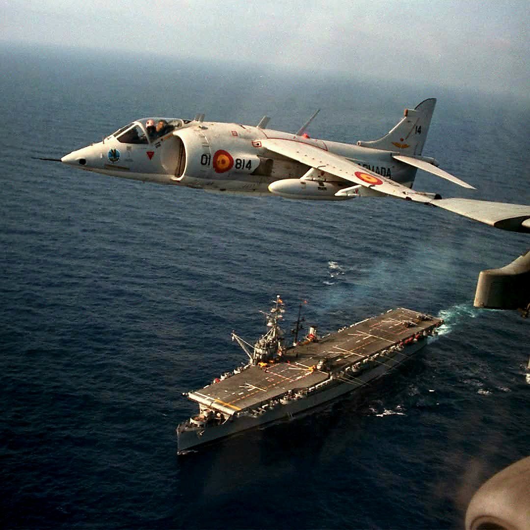RealAirPower1's tweet photo. A gorgeous view of an AV-8S Matador over the Dédalo, Spain’s first aircraft carrier. Originally the USS Cabot (CVL-28), the Dédalo was a WWII vet with a classic wooden deck. When Spain brought in the Harriers, they had to bolt metal plates onto the deck just to stop the jet exhaust from cooking the wood. Talk about armour plating an old warhorse 😉