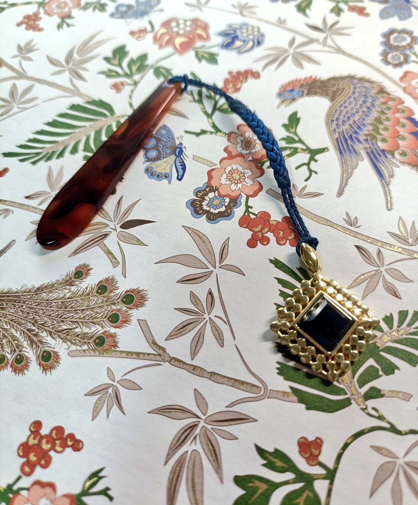 SudoPrintMaker's tweet photo. 友人のアクセサリーショップでお迎えしたネックレス。根付紐とプレートが買えた！のでペンダントトップを帯飾りにしてみました…が、昨日から夏になったので私のにわか着物チャレンジは終了の予感。眺めるためだけに買った紙の上に置いて妄想中… https://t.co/Im28pdGmM6