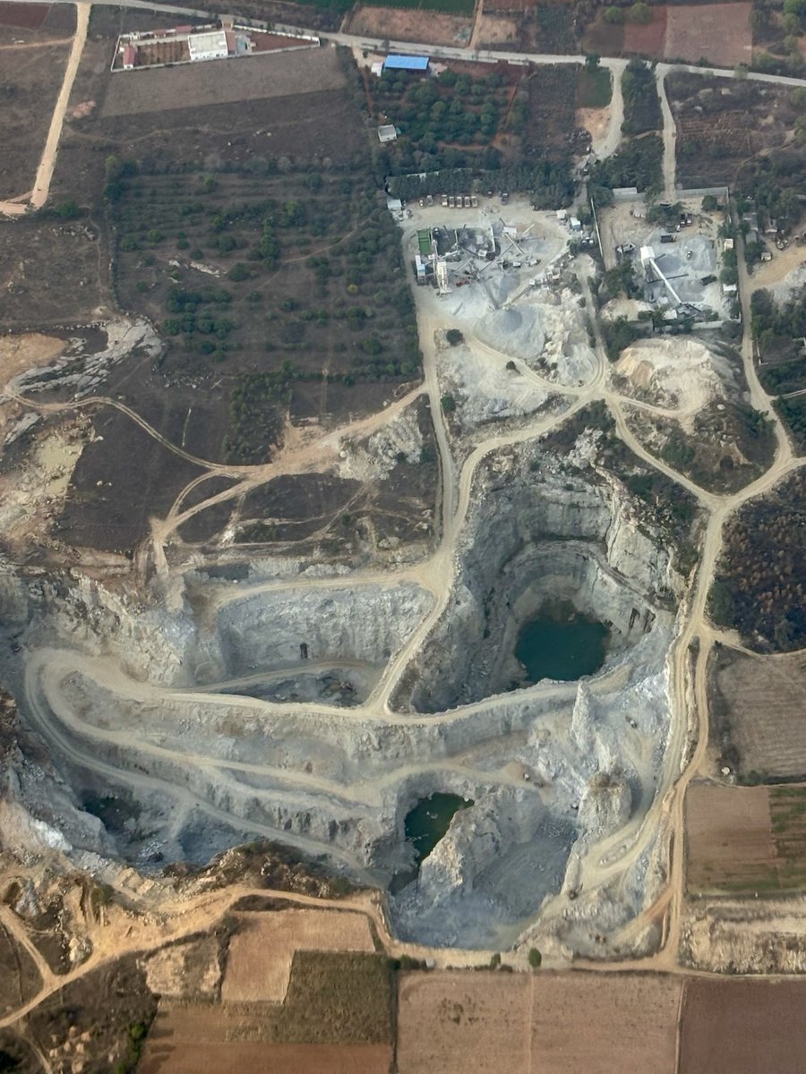 Faraz__Iqbal's tweet image. From the #sky, earth lies open wide,
A wounded canvas, stripped of pride.
Circles carved like a giant’s sigh,
Spiraling down where shadows lie.

Rust veins and ashen scars,
Etched like maps of fallen #stars.
Once it breathed in #green &amp;amp; grace,
Now time stands still in this vast