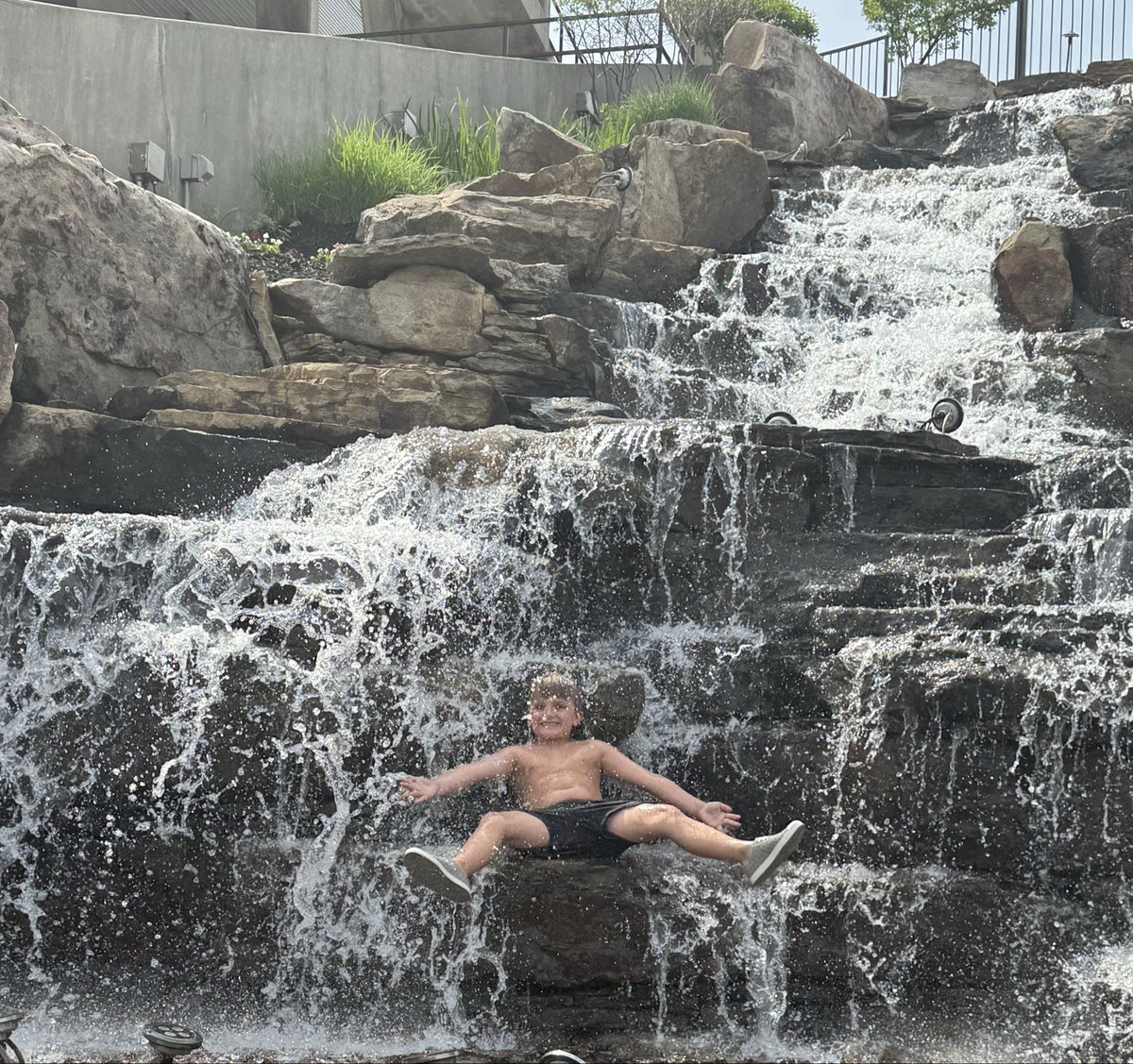 CortGrimes's tweet photo. He finally got to jump in the Centennial Bank Stadium waterfall to cool off after watching @AStateFB spring practice #9️⃣! #CoachKidPerks #WolvesUp @CoachNickGrimes https://t.co/LU7paOy1KI