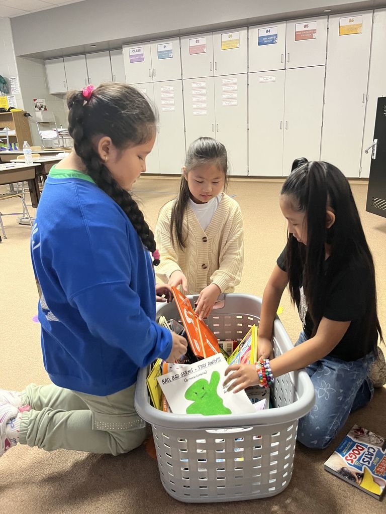 Miss Blackburn's class participates in "Free Book Fridays" each week. Here they are picking books that are just right for them. They get to keep these books to help build their own book collections and build a love for reading!