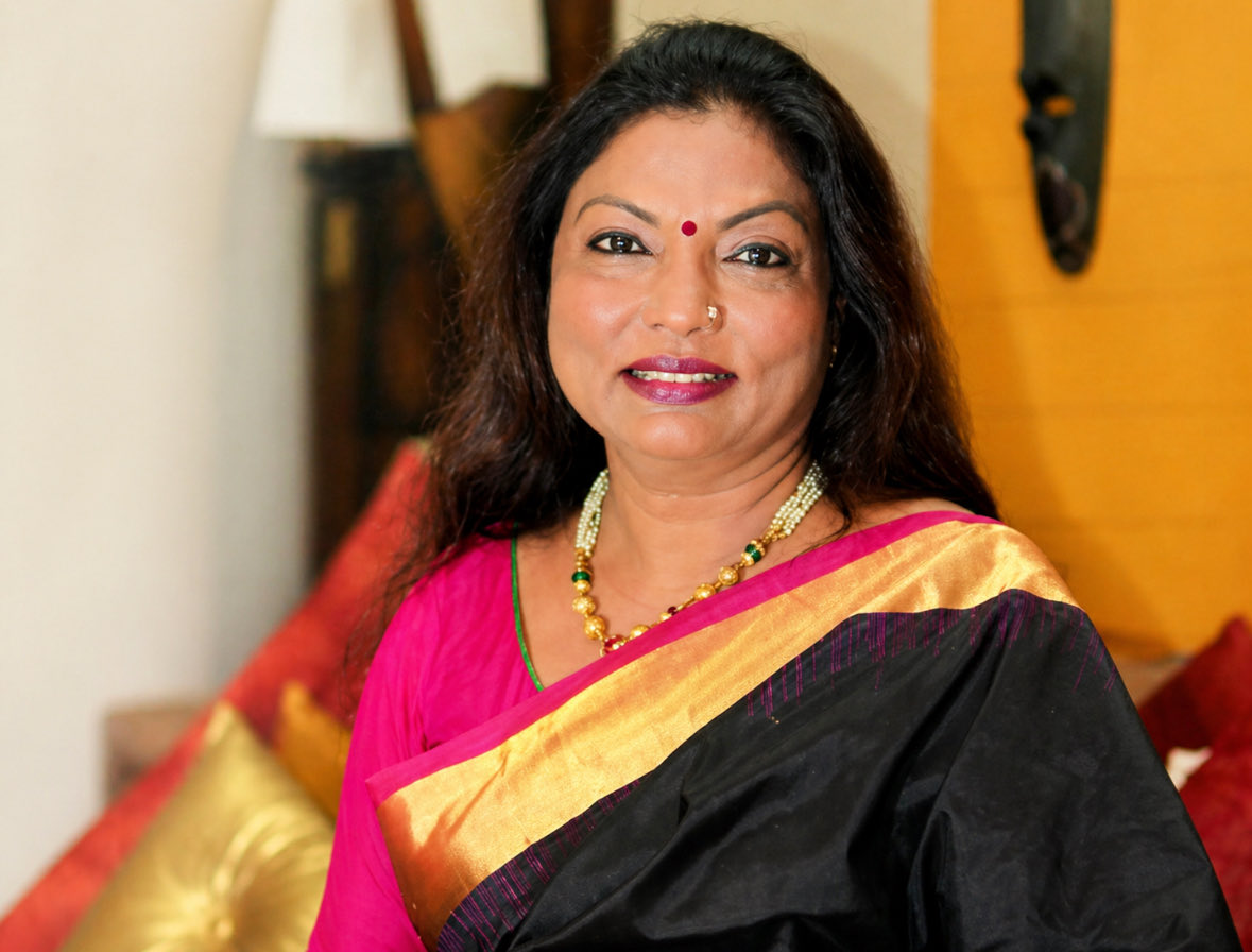 Her name is Kalpana Saroj.

She was born in 1961 in Akola, Maharashtra, into a Dalit family. Her father was a police constable. She loved school. Her teachers seated her separately because she was Dalit.

At 12, her parents married her off to a man ten years older. She moved to a