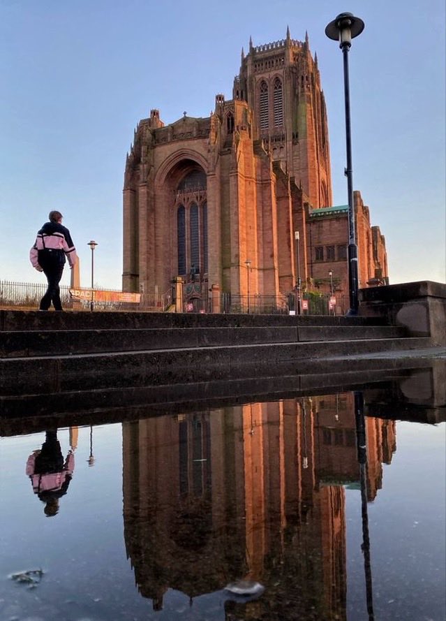 RealWorldImage's tweet image. A teenager walks towards the Liverpool Cathedral. 2022. Gary Moore photo. Real World Photographs. #Liverpool #streetphotography #cathedral #Grok #Getty #photography #England  #religion #cities #travel #reflection #realworldphotographs #garymoorephotography #photojournalism