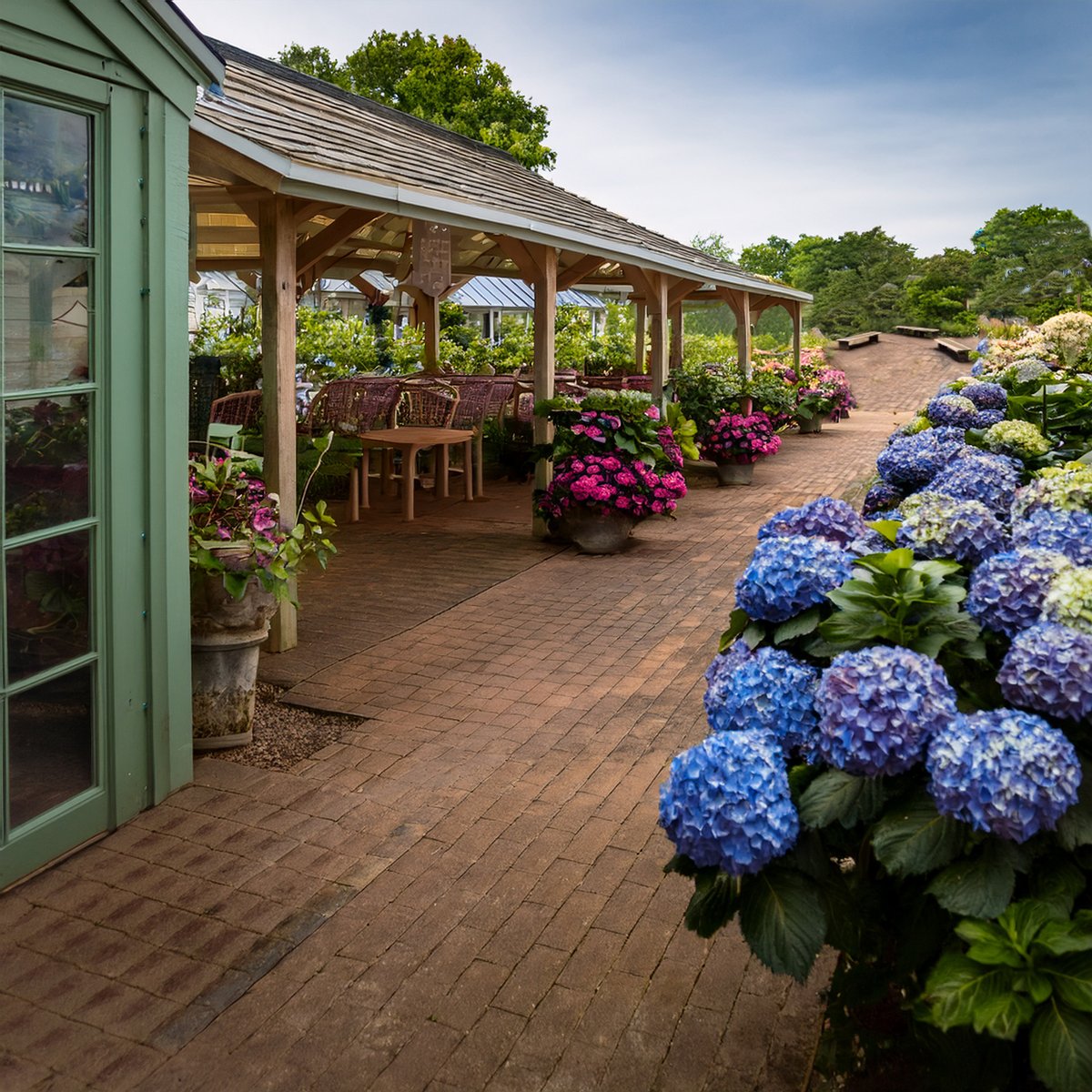 thegardenlady's tweet image. I asked Photoshop AI to give me a photo of Glass Town Gardens, the garden center in my #cozymystery "Dying For a Blue Hydrangea." I can picture Stella in the cafe, preparing one of her botanical talismans...while her sister, Allison, glares from the greenhouse. #amquerying