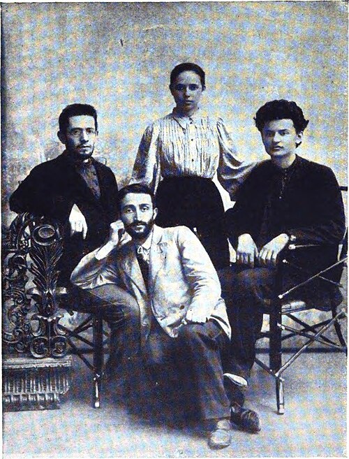 JohnReed_1917's tweet photo. I fully understand the knee jerk reaction to A.I. etc. Regardless, this is a fascinating image of a young Trotsky. His hair was historically shorter during his first marriage, so it's unlikely this image is Aleksandra Lvovna Sokolovskaya. If anyone could guess or know the other two in the images, most appreciated.