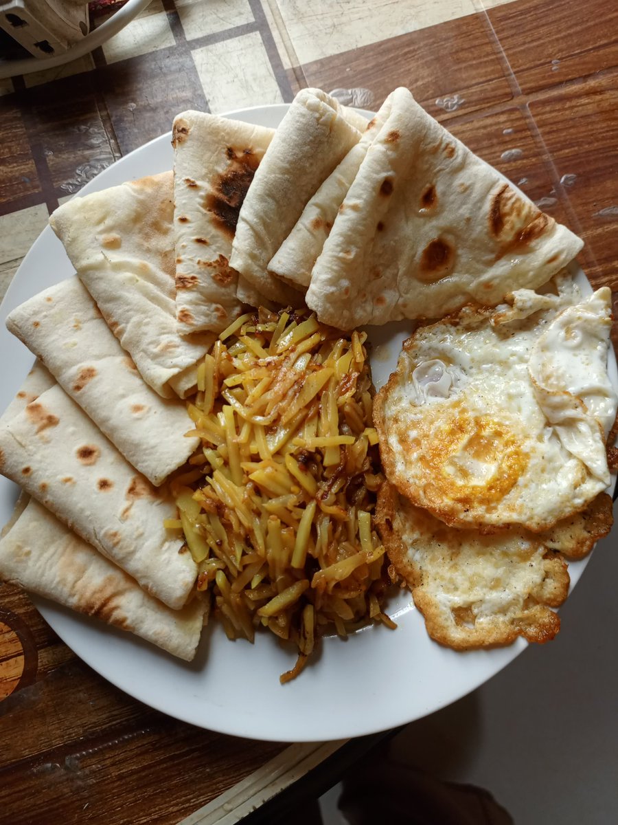 My breakfast in Dhaka, Bangladesh was absolutely delicious! 🍳🥞 Enjoying some fried eggs, savory potatoes, and warm flatbreads to start the day right. So good! 😋 #BreakfastGoals