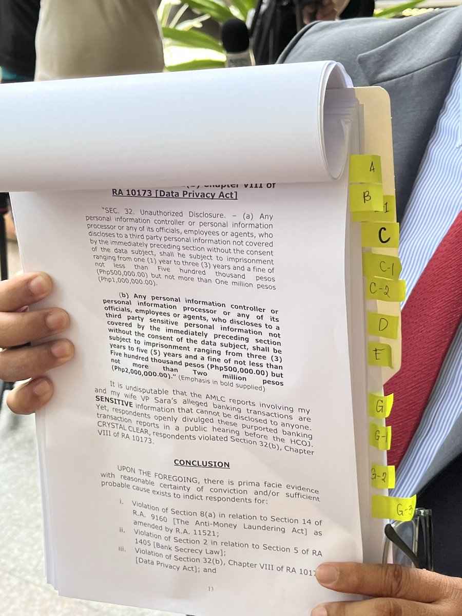 Atty. Peter Danao, lawyer of Vice President Sara Duterte’s husband Atty. Manases Carpio, holds a copy of criminal complaints filed against AMLC and BSP officials, as well as House justice committee members at the Quezon City Prosecutor’s Office on Monday for alleged violations of
