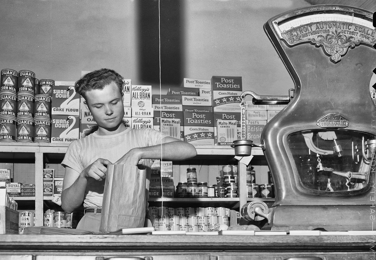 Holy cow! Y'all AMAZE me! A couple of days ago, I posted a photo taken by John Vachon in 1943 of I.V. Childers at his grocery store in San Augustine, Texas. With Mr. Childers was a young man whom Vachon noted had --- that very morning --- undergone a physical, as he had been