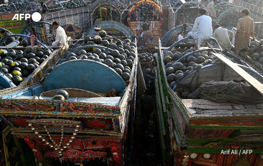 AFP's tweet image. Farmers and vendors wait for customers amid truckloads of watermelons at a wholesale market in Lahore, Pakistan

📸  Arif Ali