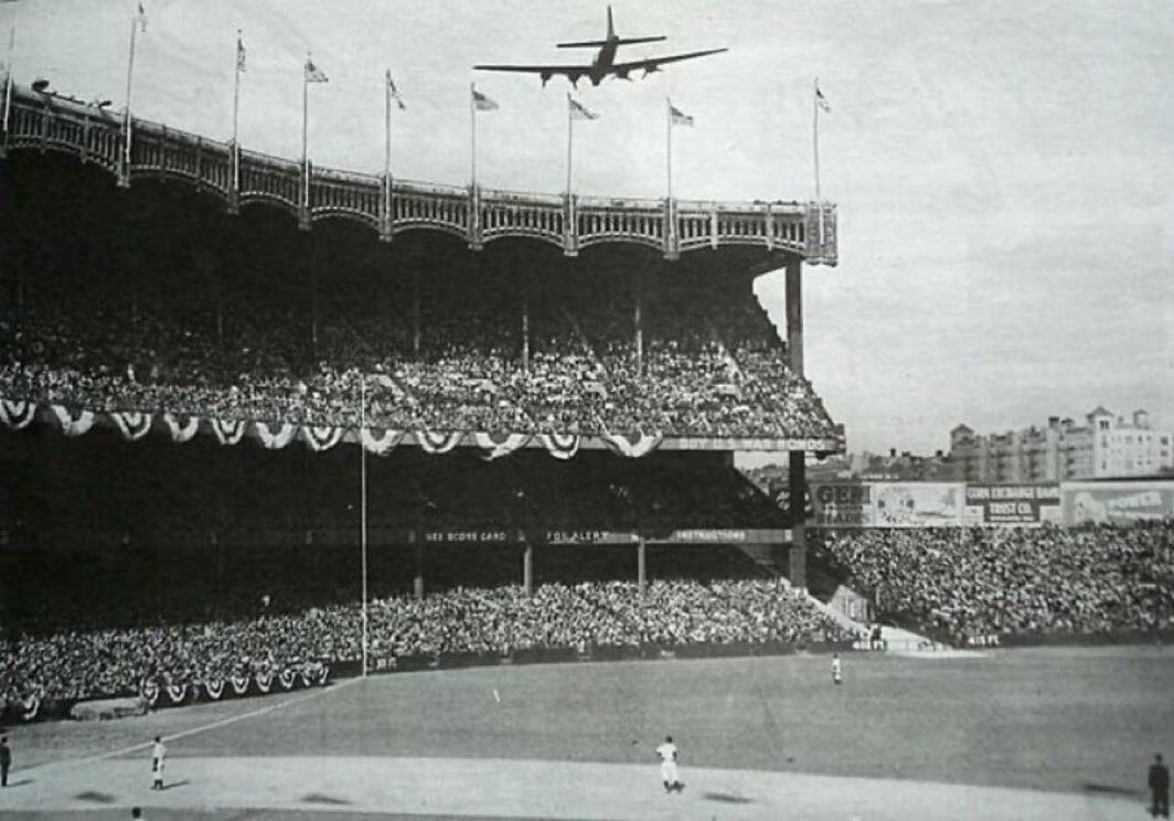 B-17 Flying Fortress bomber bound for England buzzes Yankee Stadium during Game 1 of the 1943 World Series