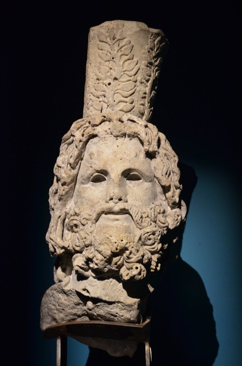 carolemadge's tweet photo. #MythologyMonday - Serapis was a syncretic Greco-Egyptian deity whose cult emerged in the early Ptolemaic period. The god combined aspects of the Egyptian gods Osiris and Apis (the sacred bull of Memphis) with features of Greek deities such as Zeus and Hades. 

Designed in part to unite Greek populations living in Egypt, Serapis became especially prominent in Hellenistic centres like Alexandria, even as traditional Egyptian worship of Osiris-Apis continued. Under the Ptolemies, he took on political importance as a state god and protector of the dynasty, linking religious devotion with loyalty to the ruler. Temples (Serapea) dedicated to him spread across Egypt and beyond, often blending Greek and Egyptian architectural and religious traditions. Hadrian later showed appreciation for the cult by dedicating an Apis bull to Serapis, reflecting its continued relevance under Roman rule.

Serapis was also associated with healing, dreams, and oracles, and his worship expanded through both royal patronage and private devotion. Sanctuaries were sometimes founded after individuals reported divine visions or repeated dreams.

In Greek-style art, Serapis was depicted as a bearded man, often enthroned, resembling Zeus or Hades, and sometimes wearing a Kalathos (a basket symbolising abundance) on his head.