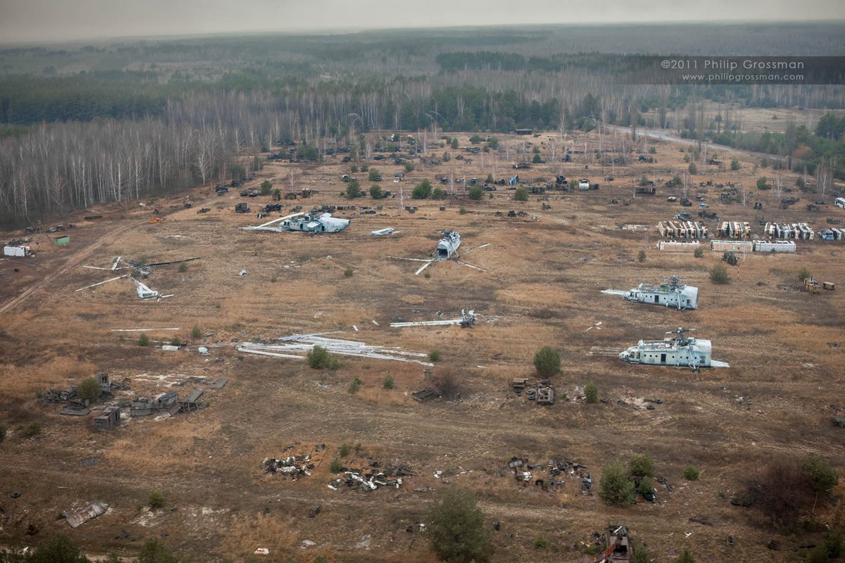 PGPImages's tweet photo. Rotary-Wing Operations & The Rassokha Graveyard in Chernobyl (for my aviation friends)

The destruction of Unit 4 required an immediate airborne logistical response. Soviet military aviation deployed Mi-6, Mi-8, and heavy-lift Mi-26 helicopters directly into the radioactive plume.

The primary objective was to smother the exposed, burning graphite core. Payloads consisted of boron carbide to absorb neutrons, lead for radiation shielding, and dolomite, sand, and clay to act as a heat sink and filter. Over 5,000 tonnes of material were dropped.

The airspace above the reactor was hostile. Pilots hovered at 200 meters, facing extreme thermal drafts that altered the aerodynamics of the helicopters. Ionizing radiation in the plume reached upward of 1,800 roentgens per hour. Crews flew blind without adequate dosimetry and improvised by placing lead sheets under their seats.

Beyond bombing the core, these assets were utilized for aerial dosimetry and spraying polymer liquids to suppress radioactive dust across the zone.

The airframes absorbed massive amounts of particulate contamination. Decontamination was impossible. The fleet was ultimately abandoned at the Rassokha vehicle graveyard.

I documented these highly contaminated airframes in 2011. By 2013, the entire inventory at Rassokha had been dismantled, scrapped, or buried.

#Chernobyl #AviationHistory #RotaryWing #Mi6 #Mi8 #NuclearEngineering #Rassokha #History #Engineering