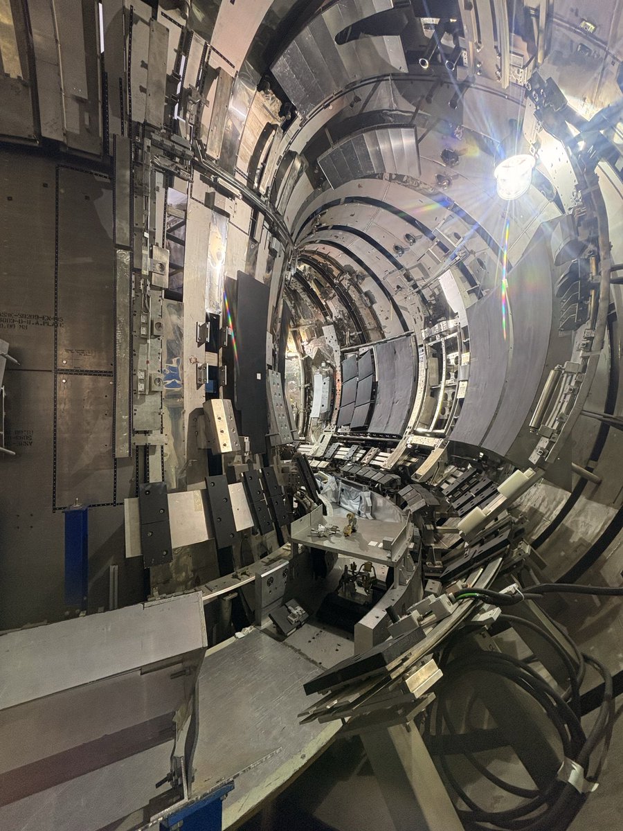 deepankarav's tweet photo. @UKAEAofficial this photo is taken by me ❤️ during open night . 

This is not the inside of JET.

It is something stranger: a full-scale rehearsal space for JET.

When the Joint European Torus was built, a spare segment of the vessel existed. Instead of becoming forgotten metal, it became one of the most useful “extra pieces” in fusion history: a 1:1 training mock-up of the inside of JET.

That is what this photo shows.

Not the burning plasma.

Not the famous record shot.

But the place where people learned how to work inside a machine that humans could no longer simply enter.

JET ran for more than 40 years at Culham in the UK. It produced its final plasma in December 2023, after 105,842 pulses. In its last deuterium–tritium campaign, it set a world record: 69 megajoules of fusion energy from only about 0.2 milligrams of fuel.

But here is the part most people never hear.

Fusion is not only about making plasma.

It is also about maintaining the machine afterwards.

Inside a real fusion device, every tile, bolt, diagnostic, cable and wall panel matters. Some components face extreme heat. Some collect fuel. Some become activated. Some have to be removed with millimetre precision by robots.

So before touching the real JET vessel, operators trained here — inside this spare-segment mock-up — using remote-handling systems such as MASCOT.

Imagine that: a piece of “extra” engineering becoming the classroom for the people and robots who would maintain one of the world’s most important fusion machines.

And now that JET is being decommissioned, this training space becomes even more important.

The next scientific question is no longer only:

Can we create fusion energy?

It is also:

Can we inspect, maintain, dismantle and learn from a fusion reactor after decades of operation?

That is why this photo is powerful.

It shows the hidden side of fusion — not the star itself, but the workshop where humans learned how to handle the machine that tried to hold one.