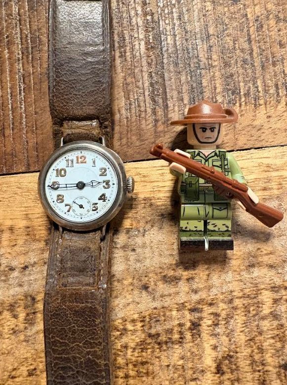HistoryBowsh's tweet photo. My #ThingThursday this week is a nice little find, a First World War era watch, it somehow still ticks if I wind it but doesn't keep time so I just leave it be. The strap claimed to be original but who knows, its certainly old. I liked it and it wasn't too much (for an antique watch). For scale, here it is next to one of my 14 Army Lego men! All the lume is gone from the hands, but I think itโs an exquisite piece of craftsmanship.