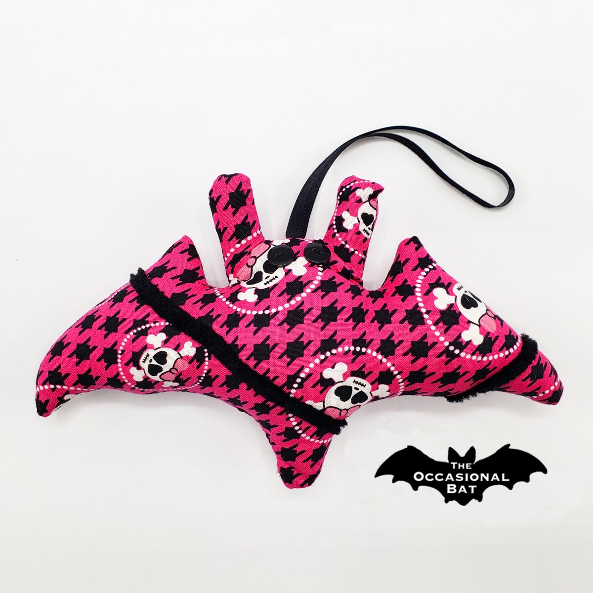OccasionalBat's tweet photo. Oh, because a skull bat ornament in pink and black houndstooth plaid is exactly what we need for sophistication this season. How utterly unique. #HomeDecor #SkullBat #Houndstooth #Ornament 🩷☠🖤 https://t.co/zetp3JQELO https://t.co/r77nccNbTR