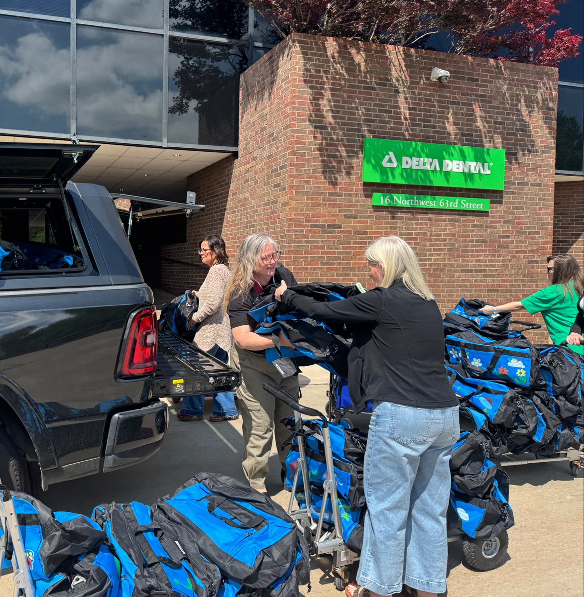 DeltaDentalOK's tweet photo. We are excited to welcome @OKDHS to our office today to collect 120 duffle bags for local foster children. Each bag was loving decorated by a member of #TeamDelta and contains a blanket, teddy bear, oral hygiene supplies, and more! https://t.co/u8LnQ5Z7hR