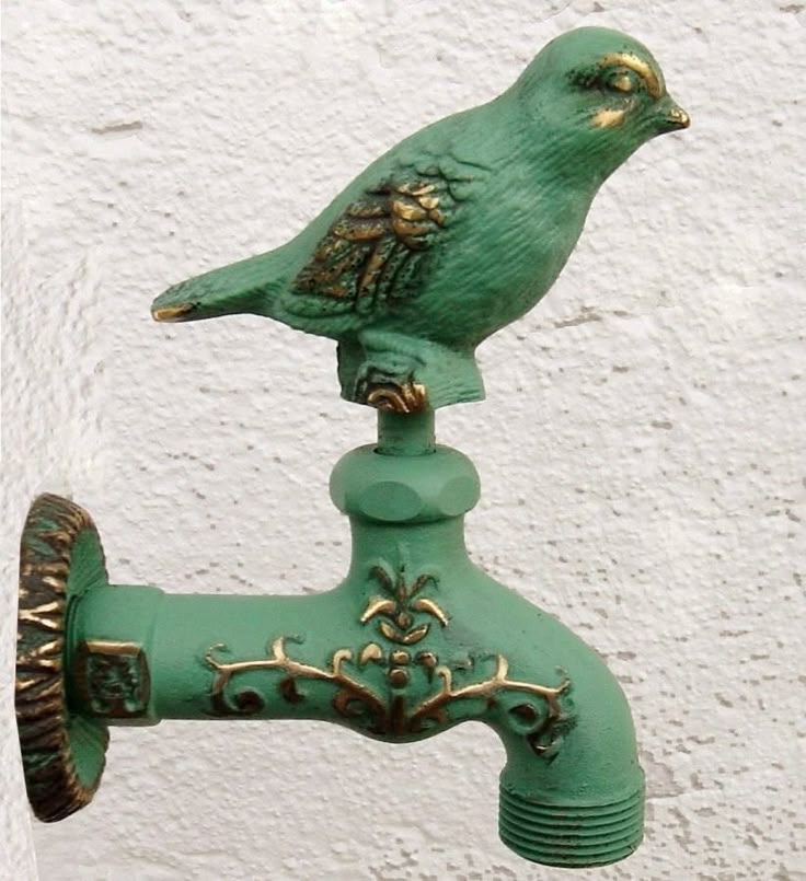 A decorative bird-shaped solid brass garden faucet.