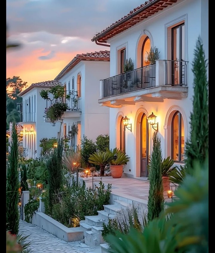 SharynCAhmad's tweet image. With warm tones, arched windows, and lush greenery, this home exudes European-inspired luxury. The soft glow of the evening lights paired with the stunning sunset makes for a picture-perfect setting. A true escape… #TimelessDesign #DreamHome #ElegantLiving #LuxuryRealEstate