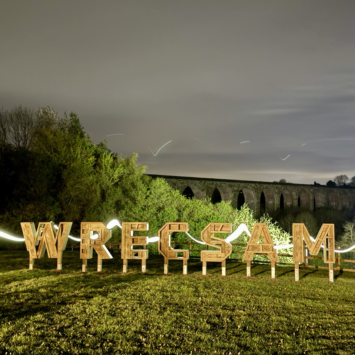 sort_of_dan's tweet photo. The new Wrecsam sign in front of Cefn Mawr Viaduct (with a train in the first picture too!) and a bit of light painting in the second! #Wrexham #Wales https://t.co/3e0d0qwfIC