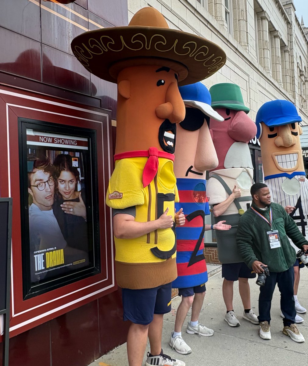SPOTTED: the iconic Milwaukee racing sausages at the world premiere of Ueck…posing outside the Oriental Theatre next to a poster for The Drama 😗🤌🏻