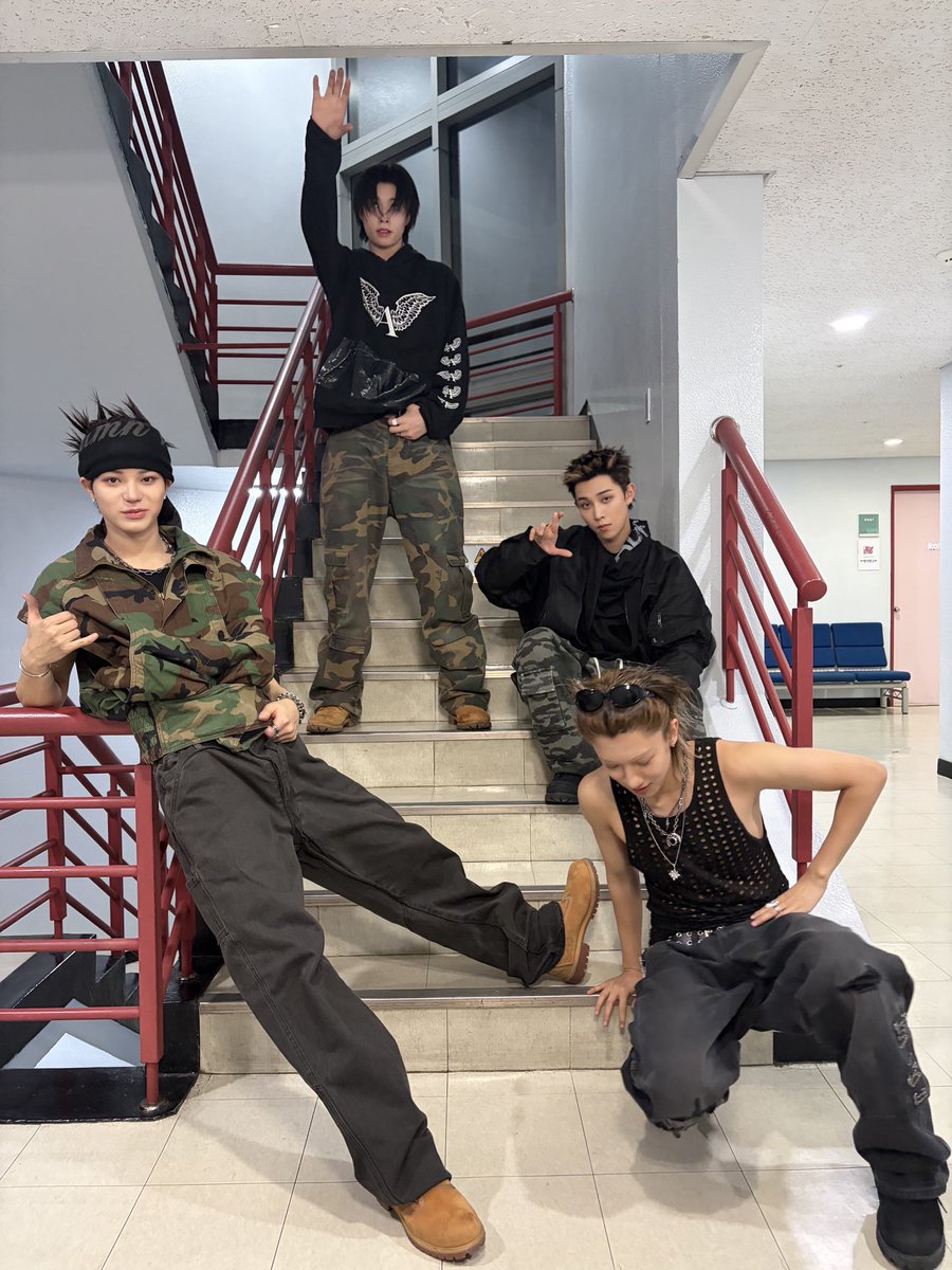 hallway lights, camo fits all over the stairs, bodies dropped, leaning, stretched out like we own every step. we keep it loose, one arm hanging, one look half serious half playing. faces close to the lens, expressions all over the place, just us filling the frame our way.