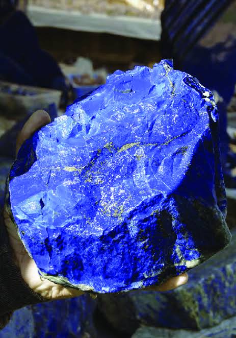 Dr_TheHistories's tweet photo. Lapis lazuli has one of the longest, most geographically expansive histories of any gemstone. The oldest known mines, Sar‑e‑Sang in Badakhshan, Afghanistan, were already active by the 7th millennium BC, supplying a deep blue stone so rare that Neolithic and Bronze Age cultures treated it as sacred. 

From these mountains, lapis traveled astonishing distances: to the Indus Valley, where beads appear in early burials; to Mesopotamia, where it entered elite ritual objects as early as the Ubaid period (c. 4900–4000 BC); and to Egypt, where it symbolized the heavens and resurrection and was embedded in amulets and royal regalia, including the mask of Tutankhamun. 

Its scarcity, intense color, and association with the divine made it more valuable than gold in many ancient societies.  

By the mid‑ to late Bronze Age (c. 2000–1000 BC), lapis lazuli had become a cornerstone of long‑distance trade linking Central Asia, the Near East, and North Africa. Caravans carried it westward along land routes through Iran and Mesopotamia, while later maritime routes expanded its reach. 

Afghan lapis dominated the ancient world because of its unmatched quality, and its movement across continents reflected shifting political alliances, trade networks, and religious symbolism. By the Middle Ages, Europe imported lapis to grind into ultramarine, the most prized blue pigment of Renaissance art, further extending its cultural legacy.  

According to scholars, Lapis Lazuli didn’t just travel as a gemstone, it quietly shaped global knowledge systems. Medieval scribes used ultramarine (ground lapis) to illuminate only the most sacred passages, but even more surprising, recent chemical analysis shows that tiny lapis particles were found in the dental plaque of a 12th‑century German nun. 

Archaeologists have found that Bronze Age artisans sometimes faked lapis lazuli by mixing cheaper blue minerals with resins or glass, because real Afghan lapis was so scarce and politically controlled. These forgeries weren’t crude, they were sophisticated enough that modern lab analysis is often needed to tell them apart. The existence of “counterfeit lapis” 4,000 years ago shows just how powerful and coveted the stone was, and how early humans developed global‑trade‑level fraud to imitate it.

#drthehistories