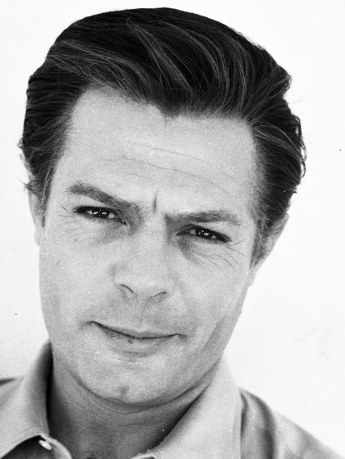 They could point a camera at him staring at a wall and audiences would weep for the unbearable beauty of modern alienation.

Its Marcello Mastroianni.