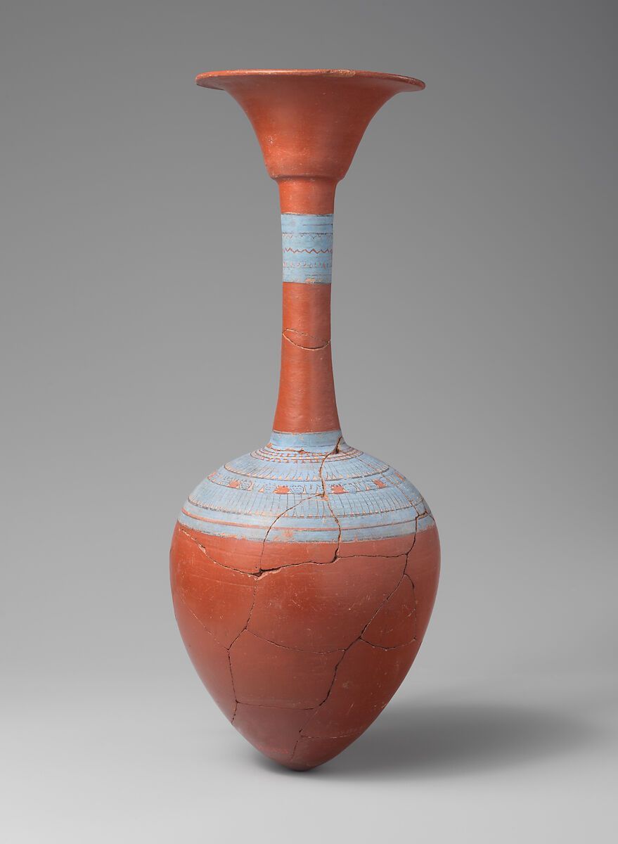 claudinecassar's tweet photo. This slender, elegant bottle, with its flaring rim in the form of an open papyrus umbel, was among the cache of objects discovered in a pit (KV 54) in the Valley of the Kings in 1907. The objects are associated with the funeral of Tutankhamun, whose tomb was discovered some fifteen years later about 200 feet away. The decoration around the neck imitates floral collars made of leaves, petals, flower buds, and berries that were worn by banquet guests and draped around vessels used at banquets. https://t.co/flYXUUozch