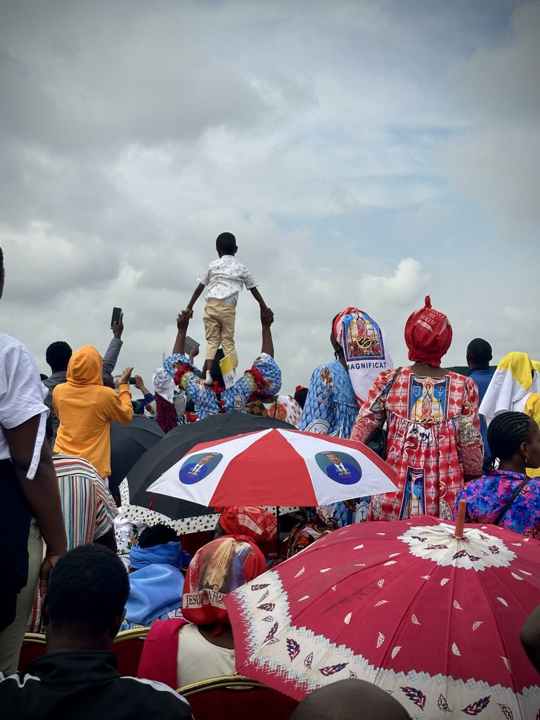 catholicourtney's tweet photo. Young boy tries to get a better view of Pope Leo XIV at the papal Mass in Yaoundé, Cameroon https://t.co/aUtMn6YEs6