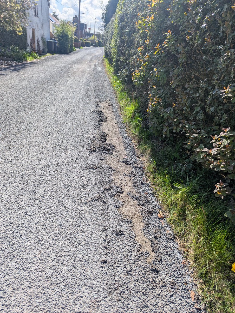 DazzPerry's tweet photo. Here's another example of why our roads are shite folks,
Kitty littered /dressed the road in our village about a week ago.
The roads sweeper has just passed thru trying to suck up all the excess stone but pulled lumps out of the new top service with it.
Amazing quality https://t.co/b1Kf63hyr1