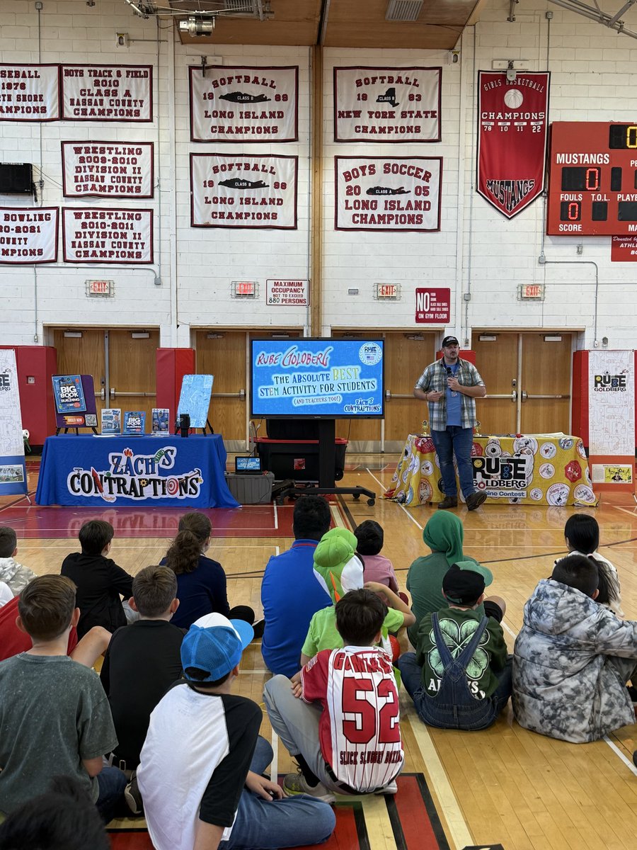 MineolaMS's tweet photo. Our @RubeGoldberg competition is underway with our very special host Zach from Zach’s Contraptions! 

Celebrating success through failure &amp; all the learning in the magical middle moments! 

#MineolaProud of our @MineolaMS teams! &amp; thank you @CailinCarlson for your hard work! https://t.co/LVtAhhPqtt