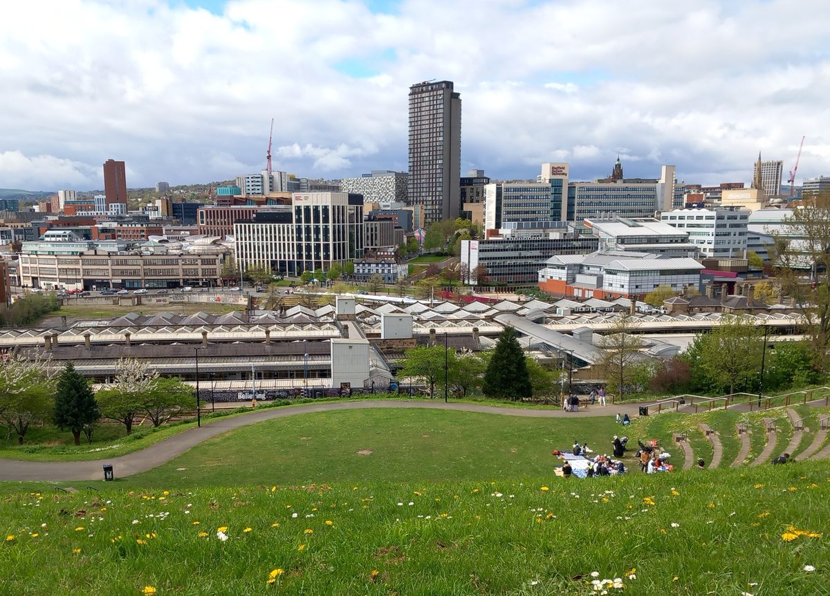 OldSheffield's tweet image. View from South Street this afternoon. Despite the ever changing skyline, the Town Hall and St Maries still peeping through. Big picnic going off on the amphitheatre #Sheffield